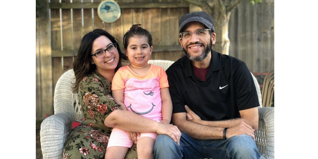 Left-to-right: Kathleen, Sydney and David Lew pose for a family portrait.