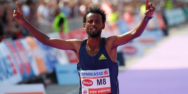 Ethiopia's Derara Hurisa celebrates after thinking he had won the race.