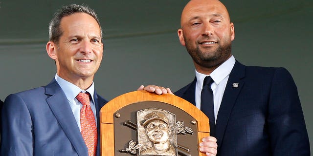 Derek Jeter poses for a photograph with his plaque with MLB Commissioner Bob Manfred (L), interim president Jeff Idelson and Chairman of the board Jane Forbes Clark during the Baseball Hall of Fame induction ceremony at Clark Sports Center on September 08, 2021 in Cooperstown, New York. 