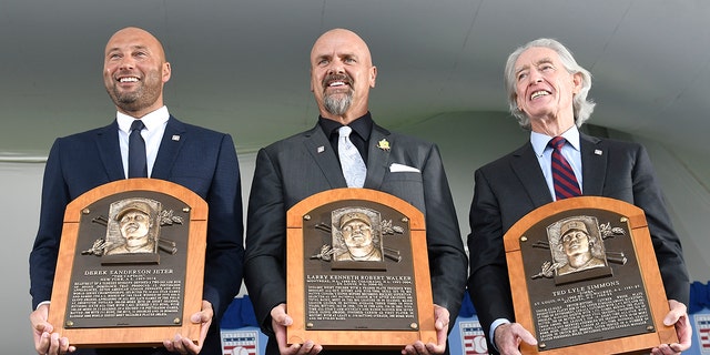 Hall of Fame inductees, from left, Derek Jeter, Larry Walker and Ted Simmons hold their plaques for photos after the induction ceremony at Clark Sports Center on Wednesday, Sept. 8, 2021, at the National Baseball Hall of Fame in Cooperstown, N.Y. (AP Photo/Hans Pennink)