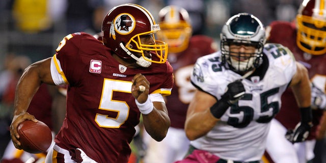 Washington Redskins quarterback Donovan McNabb (5) struggles under pressure from Stewart Bradley (55) of the Philadelphia Eagles during the fourth quarter of their NFL football game in Philadelphia, Pennsylvania on October 3, 2010.