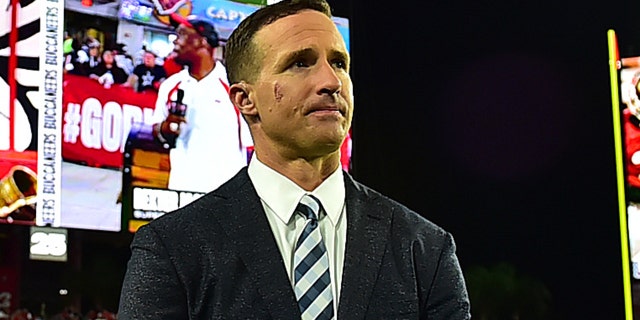 Drew Brees stands on a sideline during a game between the Tampa Bay Buccaneers and the Dallas Cowboys at Raymond James Stadium Sept. 9, 2021, in Tampa, Fla.