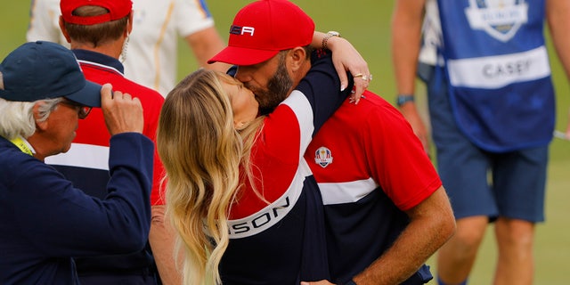 Team USA's Dustin Johnson hugs his partner Paulina Gretzky after Team USA won the Ryder Cup.