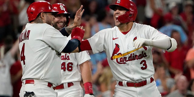 St. Louis Cardinals' Dylan Carlson (3) is congratulated by teammates Yadier Molina (4) and Paul Goldschmidt after hitting a grand slam during the eighth inning of a baseball against the San Diego Padres game Friday, Sept. 17, 2021, in St. Louis.