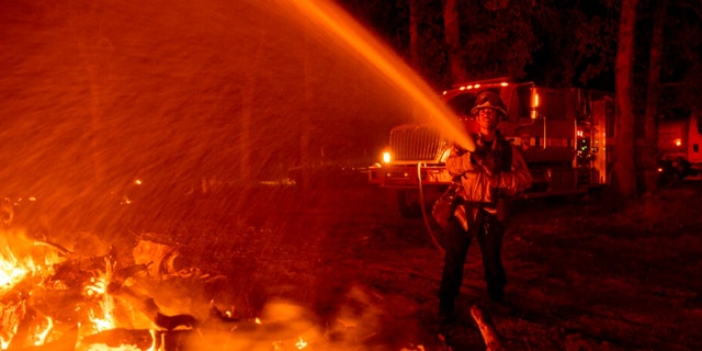 Firefighter Ron Burias battles the Fawn Fire as it spreads north of Redding, Calif. in Shasta County, on Thursday, Sept. 23, 2021.