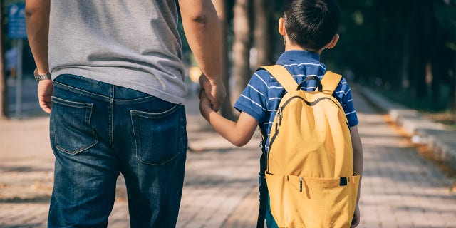 Father and son going to kindergarten