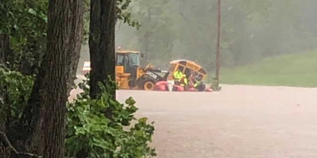 10 students and a driver were rescued off this flooded school bus in western Maryland.