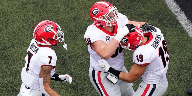Georgia tight end Brock Bowers (19) is congratulated by Jermaine Burton (7) and Warren Ericson (50) after Bowers scored a touchdown against Vanderbilt in the first half of an NCAA college football game Saturday, Sept. 25, 2021, in Nashville, Tenn.