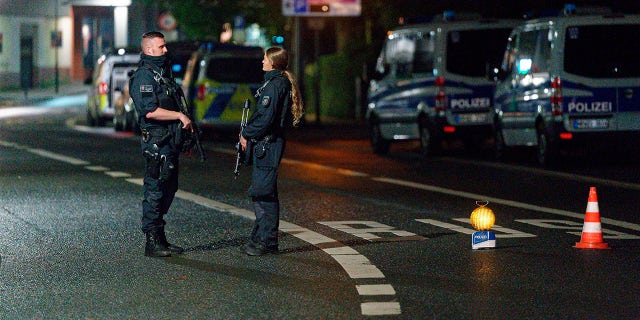 Police officers block a street in the city center during a police operation protecting the Jewish Community building in Hagen, Germany, Thursday, Sept. 16, 2021.