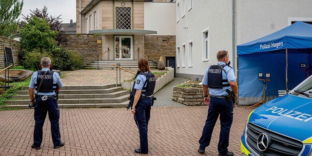 Police officers stay in front of the entrance to the Jewish Community building in Hagen, Germany, Tursday, Sept. 16, 2021. 