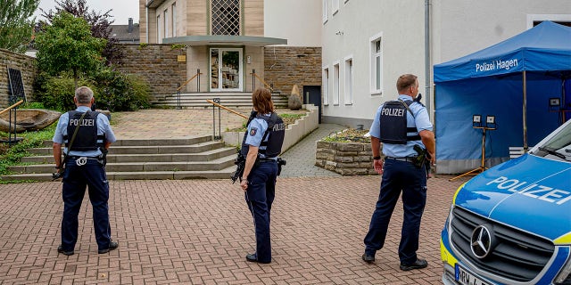 Police officers stay in front of the entrance to the Jewish Community building in Hagen, Germany, Tursday, Sept. 16, 2021.