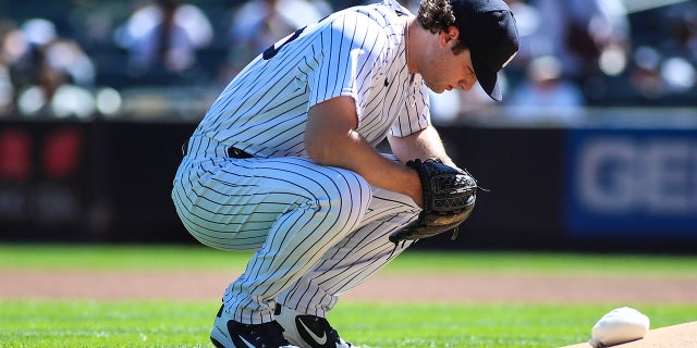 New York Yankees pitcher Gerrit Cole kneels before the start of the game against the Cleveland Indians at Yankee Stadium.