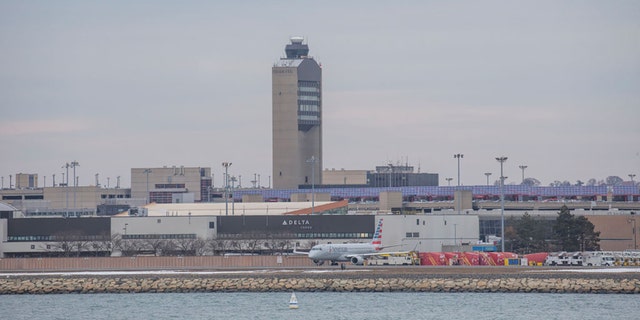 The air traffic control tower Planes at Boston Logan Airport on March 13, 2019 in Boston.