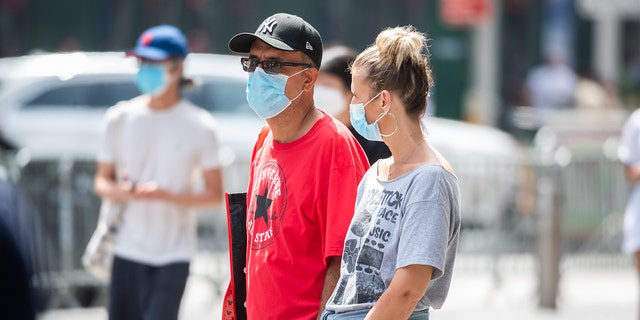 People wear face masks in Times Square on Aug. 31, 2021, in New York City.