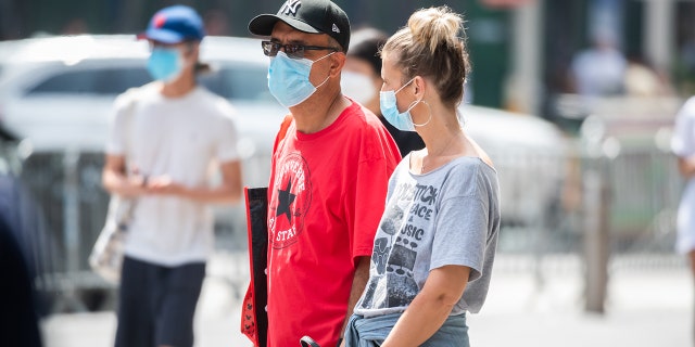 People wear face masks in Times Square on Aug. 31, 2021, in New York City.