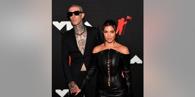 Travis Barker and Kourtney Kardashian in matching black styles at the MTV Video Music Awards.