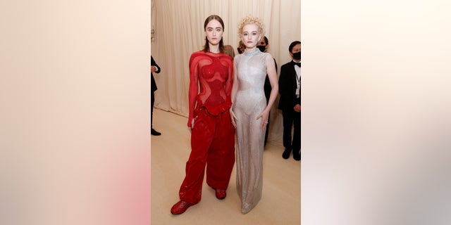 Ella Emhoff and Julia Garner are seen in contrasting red and silver sheer ensembles.