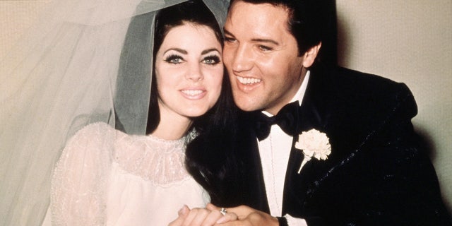 Elvis Presley sits cheek to cheek with his bride, the former Priscilla Ann Beaulieu, following their wedding May 1, 1967.