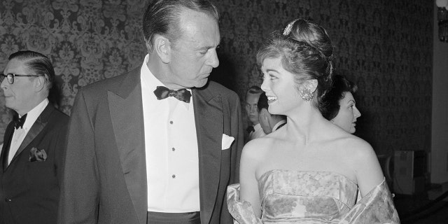 A proud father, Gary Cooper talks with his daughter, Maria, 24, during a party. Cooper was cited by the Friars for his patriotic and philanthropic activities during his three decades as a top movie star.