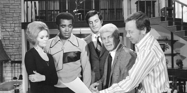 "Mission: Impossible" cast from left: Lynda Day George as Casey, Greg Morris as Barney Collier, Peter Lupus as Willy Armitage, Peter Graves as James Phelps and director Leslie H. Martinson in an off-camera moment during the episode "Stone Pillow," Oct. 20, 1971. 