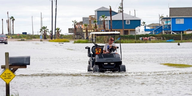 Joe Ward drives down through floodwaters from Hurricane Nicholas Tuesday, Sept. 14, 2021, in Surfside Beach, Texas. 