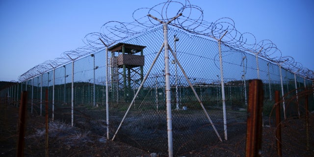 Chain link fence and concertina wire surrounds a deserted guard tower within Joint Task Force Guantánamo's Camp Delta at the U.S. Naval Base in Guantánamo Bay, Cuba, in 2016.