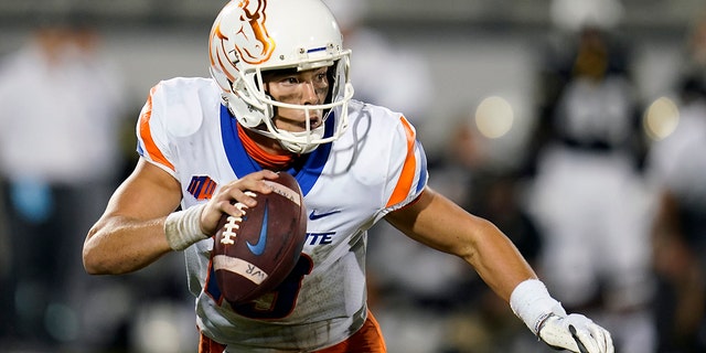 Boise State quarterback Hank Bachmeier looks for a receiver as he scrambles during the first half of the team's NCAA college football game against Central Florida on Thursday, Sept. 2, 2021, in Orlando, Fla. (AP Photo/John Raoux)