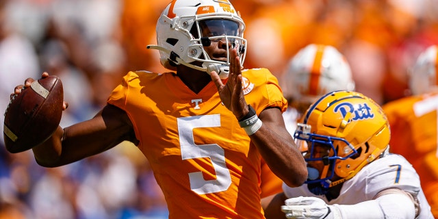 Tennessee quarterback Hendon Hooker (5) throws to receiver as he's hit by Pittsburgh linebacker SirVocea Dennis (7) during the first half of an NCAA college football game Saturday, Sept. 11, 2021, in Knoxville, Tenn. (AP Photo/Wade Payne)