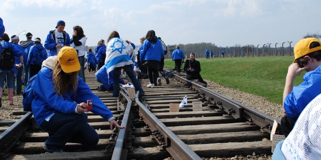 A young participant reaching to touch remnants of the past and contemplate its meaning for the future.