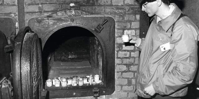 Viewing the unspeakable and remembering the victims by lighting a memorial candle at the very startling site of their demise.