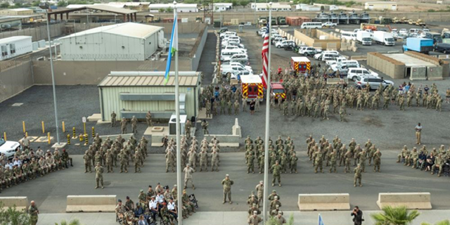 Service member with Joint Combined Task Force - Horn of Africa, stand in formation during a Patriot’s Day ceremony at Camp Lemonnier, Djibouti, Sept. 11, 2021, commemorating the 20th anniversary of the terrorist attacks on Sept. 11, 2001. The memorial ceremony included a joint formation, a multi-aircraft flyover, presentation of colors and the playing of Taps. Camp Lemonnier held multiple events in honor and remembrance of those who lost their lives both on that day and over the past two decades fighting the Global War on Terror.
