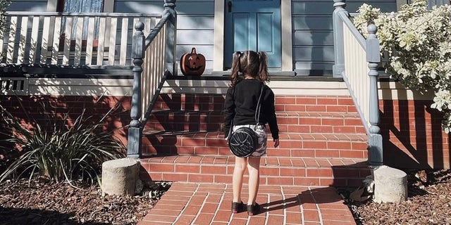 Aria Alvarado is seen in front of the character Michael Myers' house from the movie, "Halloween."