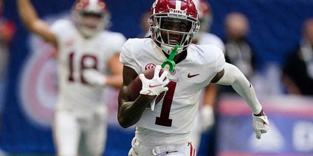 FILE - In this Saturday, Sept. 4, 2021, file photo, Alabama wide receiver Jameson Williams (1) scores a touchdown against the Miami during an NCAA college football game in Atlanta. No. 1 Alabama filled a need for playmaking speed with wide receiver Jameson Williams and defensive leadership with linebacker Henry To’oTo’o. Those offseason pickups have already paid dividends.(AP Photo/John Bazemore)