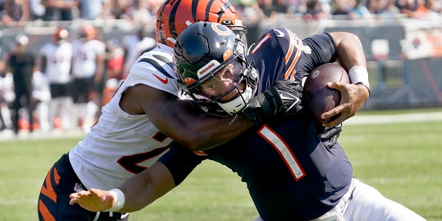 Chicago Bears quarterback Justin Fields (1) carries the ball and is tackled by Cincinnati Bengals cornerback Chidobe Awuzie during the second half of an NFL football game on Sunday, September 19, 2021 in Chicago.