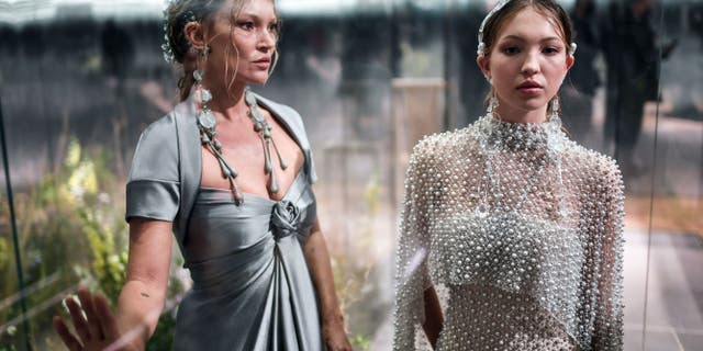 British model Kate Moss and her daughter Lila Grace Moss-Hack present creations by British designer Kim Jones for Fendi's Spring-Summer collection during the Paris Haute Couture Fashion Week in Paris, on January 27, 2021.