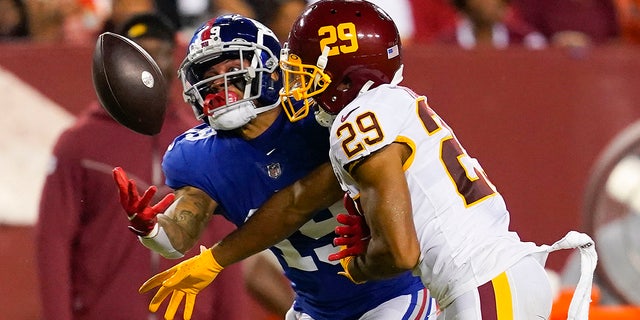 Washington football cornerback Kendall Fuller (29) prevents New York Giants wide receiver Kenny Golladay (19) from catching the ball during the second half of a football game. the NFL on Thursday, September 16, 2021, in Landover, MD.