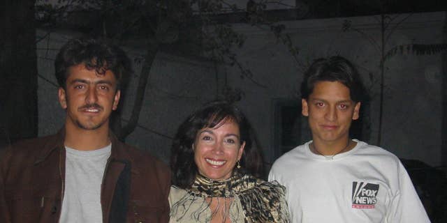 Khorshied Nusratty in Afghanistan. From left to right Massood Sanjer, Khorshied Nusratty, Mustafa Sanjer at FOX News House,,Kabul, 2002 