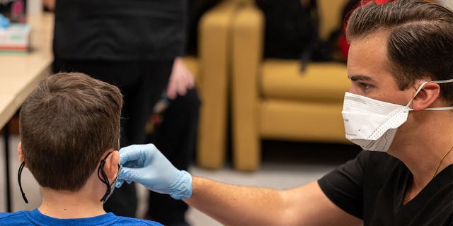 LOUISVILLE, KY - AUGUST 17: An unidentified student is administered a test by a Wild Health nurse during a COVID-19 testing day at Brandeis Elementary School on August 17, 2021 in Louisville, Kentucky.