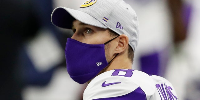 Minnesota Vikings quarterback Kirk Cousins looks up at the big-screen display during the first quarter against the Detroit Lions at Ford Field.