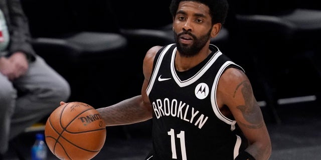 Brooklyn Nets guard Kyrie Irving handles the ball during an NBA basketball game against the Dallas Mavericks in Dallas May 6, 2021. Unable to attend the Brooklyn Nets' media day, Irving asked for privacy Monday when pressed about his vaccination status and availability for home games.