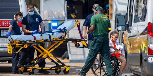 Paramedics standby at a mass shelter where about 800 residents were reportedly packed into a warehouse for Hurricane Ida, Thursday, Sep.t 2, 2021 in New Orleans.