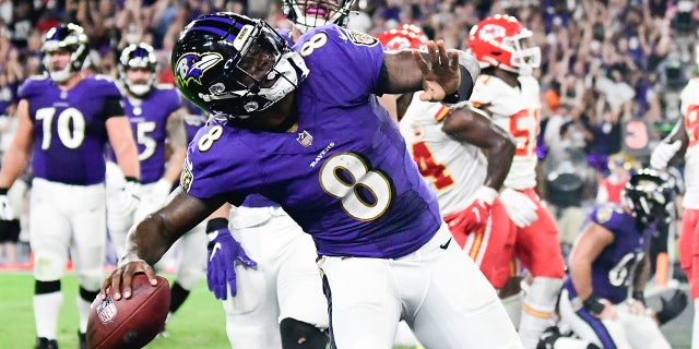 Baltimore Ravens quarterback Lamar Jackson (8) celebrates scoring a fourth quarter touchdown against the Kansas City Chiefs at M&T Bank Stadium.