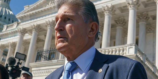 Sen. Joe Manchin, D-W.Va., a centrist Democrat vital to the fate of President Joe Biden's $3.5 trillion domestic agenda, is surrounded by reporters outside the Capitol in Washington, Wednesday, Sept. 29, 2021. (AP Photo/J. Scott Applewhite)