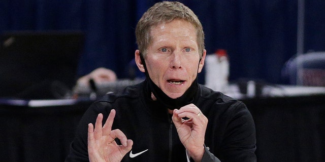 Gonzaga coach Mark Few waves to players during the second half of an NCAA college basketball game against Santa Clara in Spokane, Washington. 