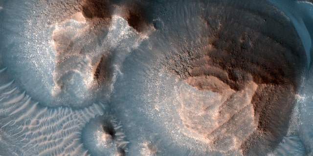 This image shows several craters in Arabia Terra filled with layered rock, which are often exposed in rounded hills.  The clear layers are about the same thickness, giving a stair look.  The process that formed these sedimentary rocks is not yet well understood.  They could have formed from sand or volcanic ash blown into the crater or into water if the crater housed a lake.  The image was taken by a camera, the High Resolution Imaging Experiment, on NASA's Mars Reconnaissance Orbiter.