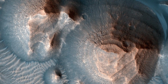 This image shows several craters in Arabia Terra that are filled with layered rock, often exposed in rounded mounds. The bright layers are roughly the same thickness, giving a stair-step appearance. The process that formed these sedimentary rocks is not yet well understood. They could have formed from sand or volcanic ash that was blown into the crater or in water if the crater hosted a lake. The image was taken by a camera, the High Resolution Imaging Experiment, on NASA's Mars Reconnaissance Orbiter.