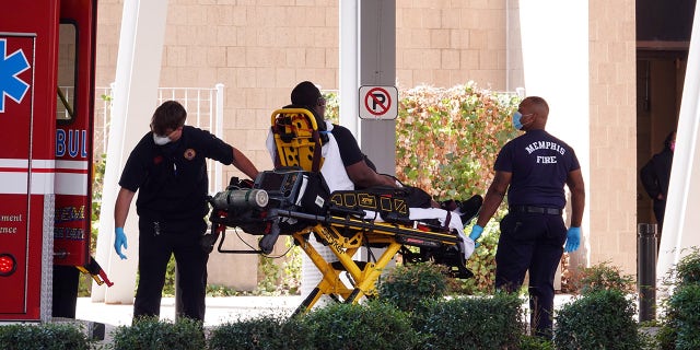 A patient is unloaded from an ambulance.