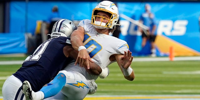 Los Angeles Chargers quarterback Justin Herbert is hit by Dallas Cowboys linebacker Micah Parsons as he throws during the second half of an NFL football game Sunday, Sept. 19, 2021, in Inglewood, Calif. 