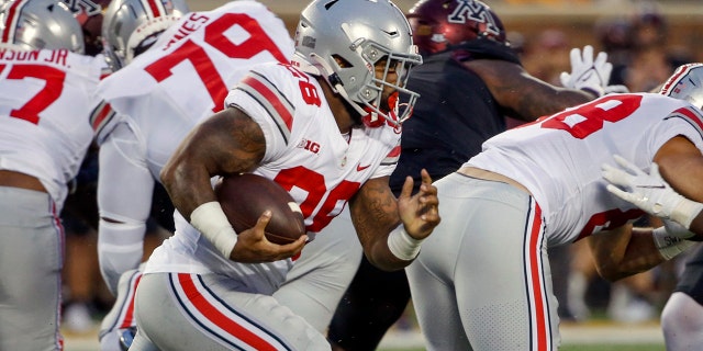 Ohio State running back Miyan Williams (28) rushes for a touchdown against Minnesota in the first quarter of an NCAA college football game Thursday, Sept. 2, 2021, in Minneapolis. (AP Photo/Bruce Kluckhohn)
