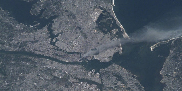 Visible from the space, a plume of smoke rises from the Manhattan area after two planes crashed into the towers of the World Trade Center.  This photo was taken from the metropolitan New York City (and other parts of New York as well as New Jersey) on the morning of September 11, 2001. "Our prayers and thoughts go out to all the people there, and everywhere else," said Station Commander Frank Culbertson of Expedition 3, following the terrorist attacks.